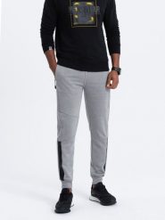 Spodnie męskie dresowe z przeszyciami - szary melanż V3. Szare spodnie dresowe męskie Ombre Clothing, bez wzorów, z bawełny. W wyprzedaży za 39.99 zł.