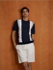 Szorty chino regular fit - biały. Białe szorty męskie Reserved, z bawełny, bez kołnierzyka. Za 119.99 zł.