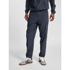 Spodnie dresowe tkane Hummel Pulse. Brązowe spodnie dresowe męskie HUMMEL, bez wzorów, z dresówki. Za 236.50 zł.