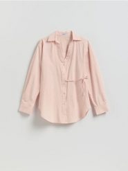 Bawełniana koszula z wiązaniem - brzoskwiniowy. Pomarańczowe koszule damskie Reserved, l, bez wzorów, z bawełny, bez kołnierzyka, bez ramiączek. Za 129.99 zł.