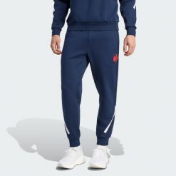 Spodnie France Travel. Niebieskie spodnie dresowe męskie Adidas, bez wzorów, z dresówki. Za 439.00 zł.