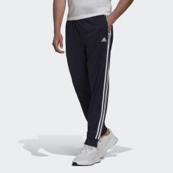 Primegreen Essentials Warm-Up Tapered 3-Stripes Track Pants. Białe spodnie dresowe męskie Adidas, bez wzorów, z dresówki. Za 182.00 zł.