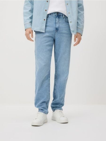 Jeansy carrot z efektem sprania - niebieski. Niebieskie jeansy męskie Reserved. Za 139.99 zł.