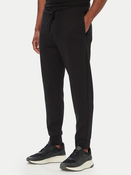 BOSS Spodnie dresowe Hadiko 50565748 Czarny Regular Fit. Czarne spodnie dresowe męskie Boss, bez wzorów, z bawełny. Za 629.99 zł.