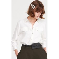Tunika ze strukturalnej tkaniny - Kremowy. Białe tuniki damskie Reserved, bez wzorów, z tkaniny, bez kołnierzyka, bez ramiączek. Za 139.99 zł.