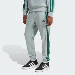 Spodnie Essential 3-Stripes French Terry. Zielone spodnie materiałowe męskie Adidas, bez wzorów, z materiału, sportowe. Za 219.00 zł.