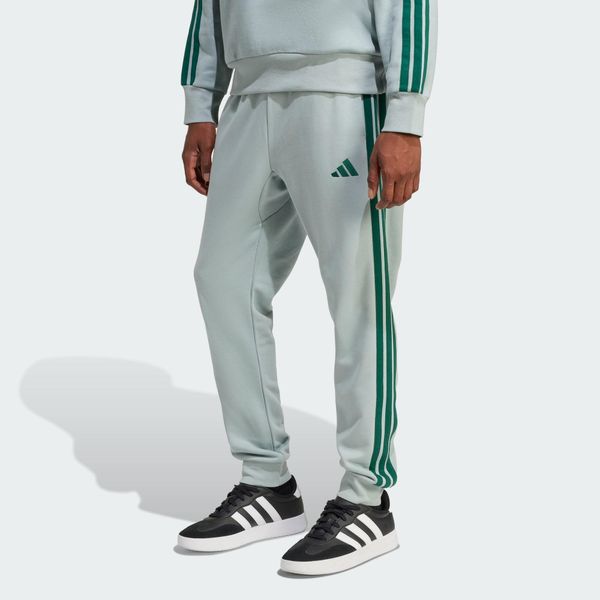 Spodnie Essential 3-Stripes French Terry. Zielone spodnie materiałowe męskie Adidas, bez wzorów, z materiału, sportowe. Za 219.00 zł.