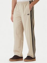 Adidas Spodnie dresowe KE0116 Beżowy Loose Fit. Brązowe spodnie dresowe męskie Adidas, bez wzorów, z dresówki. Za 348.99 zł.