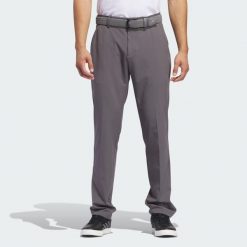 Spodnie Ultimate365 Tapered Golf. Szare spodnie materiałowe męskie Adidas, bez wzorów, z elastanu, klasyczne, z standardowym stanem. Za 334.40 zł.