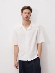 Bawełniana koszula oversize - biały. Białe koszule męskie Reserved, l, bez wzorów, z bawełny, bez kołnierzyka, bez ramiączek. W wyprzedaży za 99.99 zł.