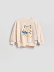 Bluza z nadrukiem - złamana biel. Bluzy i bluzki niemowlęce Reserved, bez wzorów, z bawełny, bez ramiączek, bez kaptura. Za 45.99 zł.
