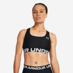 Stanik sportowy HeatGear® Armour Mid Branded. Czarne biustonosze sportowe damskie Under Armour, bez wzorów, z materiału. Za 99.99 zł.