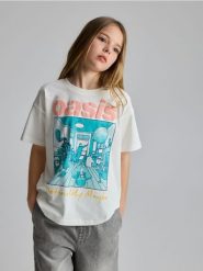 T-shirt Oasis - złamana biel. Koszulki dziewczęce Reserved, bez wzorów, z bawełny, bez ramiączek. Za 45.99 zł.