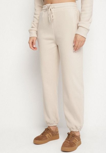 Beżowe Bawełniane Spodnie Dresowe ze Sznurkiem i Polarową Podszewką Saliavera. Brązowe spodnie dresowe damskie Born2be, l, bez wzorów, z bawełny. Za 34.99 zł.