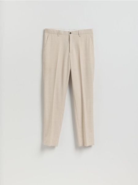 Garniturowe spodnie slim fit - beżowy. Brązowe spodnie wizytowe męskie Reserved, z tkaniny. Za 169.99 zł.