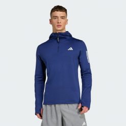 Bluza z kapturem Own The Run Winterized Hooded Half-Zip. Niebieskie bluzy sportowe męskie Adidas, bez wzorów, sportowe, bez kołnierzyka, bez ramiączek. Za 279.00 zł.