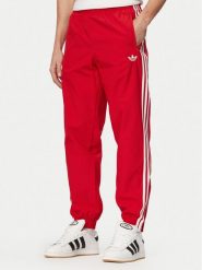 Adidas Spodnie dresowe Firebird Woven KE1369 Czerwony Regular Fit. Czerwone spodnie dresowe męskie Adidas, bez wzorów, z dresówki. Za 299.99 zł.