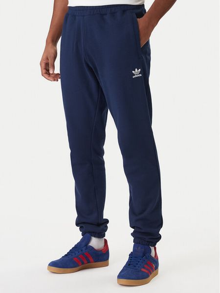 Adidas Spodnie dresowe Trefoil Essentials JD2423 Granatowy Slim Fit. Niebieskie spodnie dresowe męskie Adidas, bez wzorów, z bawełny. Za 239.99 zł.