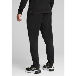 Męskie tkane spodnie TAD ESSENTIALS o zwężanym kroju PUMA Black. Czarne spodnie materiałowe męskie Puma, bez wzorów, sportowe. Za 229.00 zł.