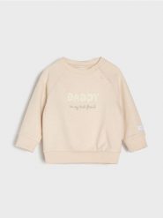 Bawełniana bluza crewneck z napisem - kremowy. Białe bluzy i bluzki niemowlęce Sinsay, bez wzorów, z bawełny, bez ramiączek, bez kaptura. Za 15.99 zł.