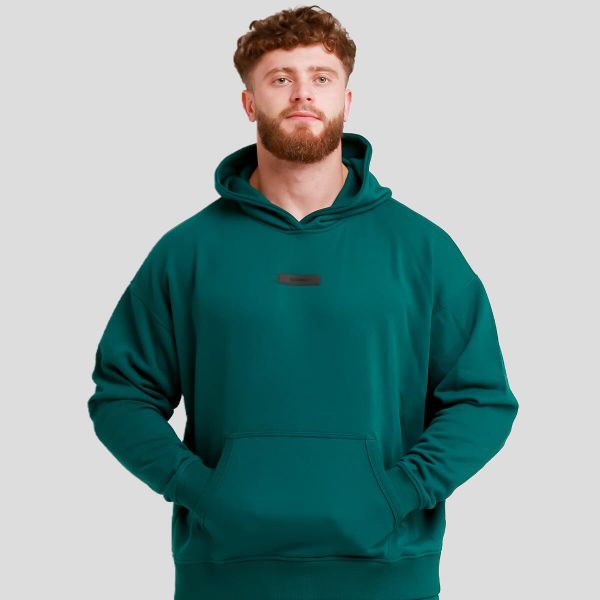 Bluza męska z kapturem oversize zielona Unstoppable. Zielone bluzy sportowe męskie GYMBEAM, bez wzorów, z bawełny, sportowe, bez kołnierzyka, bez ramiączek. Za 118.90 zł.