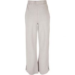 Spodnie z rozcięciem dla kobiet Urban Classics Heavy Terry Garment Dye GT. Szare spodnie dresowe damskie Urban Classics, bez wzorów. Za 267.50 zł.
