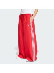 Adidas Spodnie dresowe Firebird Adilenium KD6299 Czerwony Regular Fit. Czerwone spodnie dresowe damskie Adidas, xs, bez wzorów, z dresówki. Za 379.99 zł.