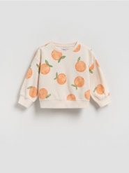 Luźna bluza z nadrukiem - kremowy. Białe bluzy i bluzki niemowlęce Reserved, bez wzorów, z bawełny, bez ramiączek, bez kaptura. Za 49.99 zł.
