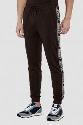 GUESS Brązowe męskie spodnie dresowe z lampasami New Arlo. Brązowe spodnie dresowe męskie Guess, z aplikacjami, z dresówki. W wyprzedaży za 286.99 zł.