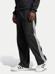Adidas Spodnie dresowe adicolor Firebird IZ4801 Czarny Baggy Fit. Czarne spodnie dresowe męskie Adidas, bez wzorów, z dresówki. Za 239.99 zł.