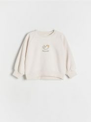 Bluza z nadrukiem - złamana biel. Bluzy i bluzki niemowlęce Reserved, bez wzorów, z bawełny, bez ramiączek, bez kaptura. W wyprzedaży za 29.99 zł.