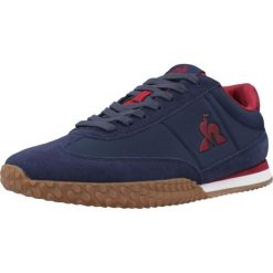 Buty LE COQ SPORTIF VELOCE I Niebieski. Niebieskie buty trekkingowe męskie Le Coq Sportif, ze skóry, bez zapięcia, trekkingowe. Za 312.99 zł.