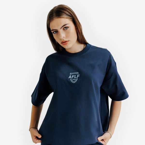 Koszulka damska Crop Graphic Heritage. Niebieskie bluzki damskie Decathlon, xs, bez wzorów, z bawełny, retro, bez kołnierzyka, bez ramiączek. Za 79.99 zł.