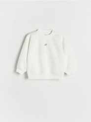 Bluza z nadrukiem - złamana biel. Bluzy i bluzki niemowlęce Reserved, bez wzorów, z bawełny, bez ramiączek, bez kaptura. W wyprzedaży za 27.99 zł.