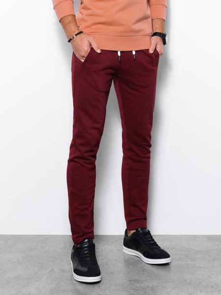 Spodnie męskie dresowe bez ściągacza na nogawce - burgundowe V2. Czerwone spodnie dresowe męskie Ombre Clothing, bez wzorów, z dresówki. W wyprzedaży za 69.99 zł.