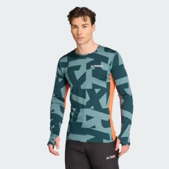 Koszulka z długim rękawem Multi Synthetic Base Layer. Niebieskie koszulki męskie z długim rękawem Adidas, l. W wyprzedaży za 142.35 zł.