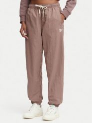 Reebok Spodnie dresowe Kalina RK25694CCW - LIGHT COCOA/LINEN Brązowy Relaxed Fit. Brązowe spodnie dresowe damskie Reebok, xs, bez wzorów, z dresówki. Za 259.99 zł.
