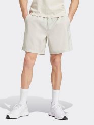 Adidas Szorty w kolorze kremowym rozmiar: L. Brązowe szorty męskie Adidas, bez kołnierzyka. Za 100.99 zł.