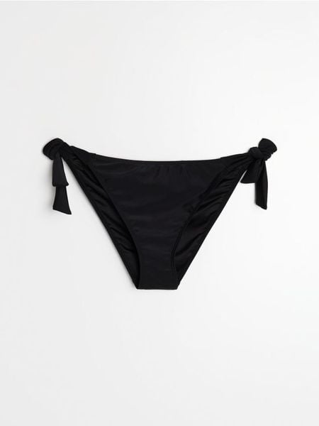 Dół od bikini wiązany po bokach - czarny. Czarne bikini damskie Sinsay, bez wzorów. Za 15.99 zł.