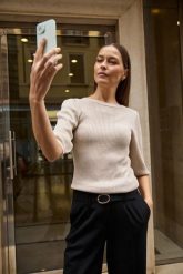 Prążkowany sweter z bufiastymi rękawami beżowy. Brązowe swetry klasyczne damskie MOODO, l, prążkowane, bez kołnierzyka. Za 109.99 zł.