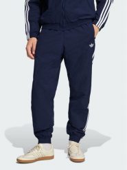 Adidas Spodnie dresowe FIREBIRD WOVEN Błękitny Regular Fit. Niebieskie spodnie dresowe męskie Adidas, bez wzorów, z dresówki. Za 298.99 zł.