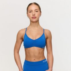 Biustonosz damski fitness ze skrzyżowanymi ramiączkami niebieski Fierce. Niebieskie biustonosze sportowe damskie GYMBEAM, bez wzorów, z elastanu. Za 84.90 zł.