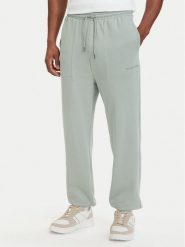 Tommy Hilfiger Spodnie dresowe Essential UM0UM03911 Zielony jasny Relaxed Fit. Zielone spodnie dresowe męskie Tommy Hilfiger, bez wzorów, z bawełny. Za 289.99 zł.