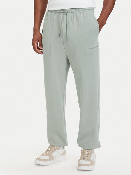 Tommy Hilfiger Spodnie dresowe Essential UM0UM03911 Zielony jasny Relaxed Fit. Zielone spodnie dresowe męskie Tommy Hilfiger, bez wzorów, z bawełny. Za 191.99 zł.