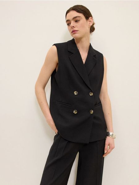 Długa dwurzędowa kamizelka - czarny. Czarne kamizelki damskie Reserved, l, z wiskozy, długie. W wyprzedaży za 99.99 zł.