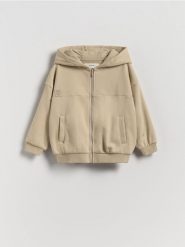 Bawełniana bluza z kapturem - kremowy. Białe bluzy i bluzki niemowlęce Reserved, bez wzorów, z bawełny, bez ramiączek, z kapturem. Za 49.99 zł.