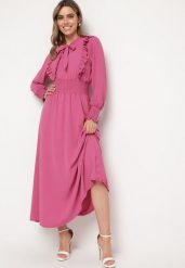 Ciemnoróżowa Rozkloszowana Sukienka Maxi Wiązana przy Dekolcie Ozdobiona Falbankami Nuteki. Czerwone sukienki damskie Born2be, na imprezę, m, bez wzorów, eleganckie, bez kołnierzyka, bez ramiączek, maxi, rozkloszowane. W wyprzedaży za 103.99 zł.