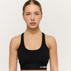 Biustonosz sportowy damski boks z regulowanymi ramiączkami Combat. Czarne biustonosze sportowe damskie GYMBEAM, bez wzorów, z elastanu. Za 85.90 zł.