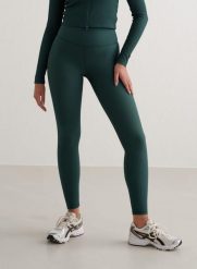 Damskie legginsy wysoki stan, kieszonka Ribbed Performance ciemnoszmaragdowe. Zielone legginsy damskie Aim'n, l, bez wzorów, z elastanu. Za 152.40 zł.