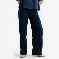 Spodnie dresowe damskie Heritage. Niebieskie spodnie dresowe damskie Decathlon, m, bez wzorów, z dresówki. Za 119.99 zł.